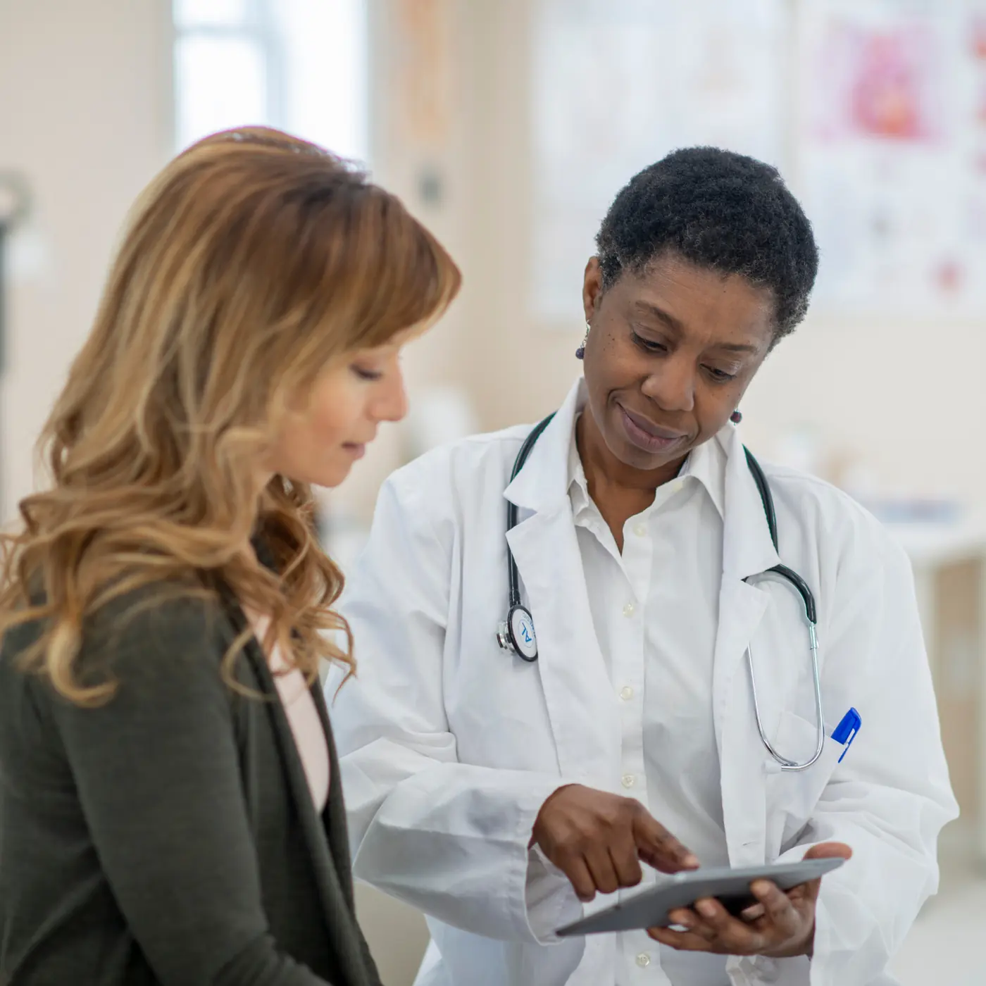 Physician reviewing a tablet with a patient